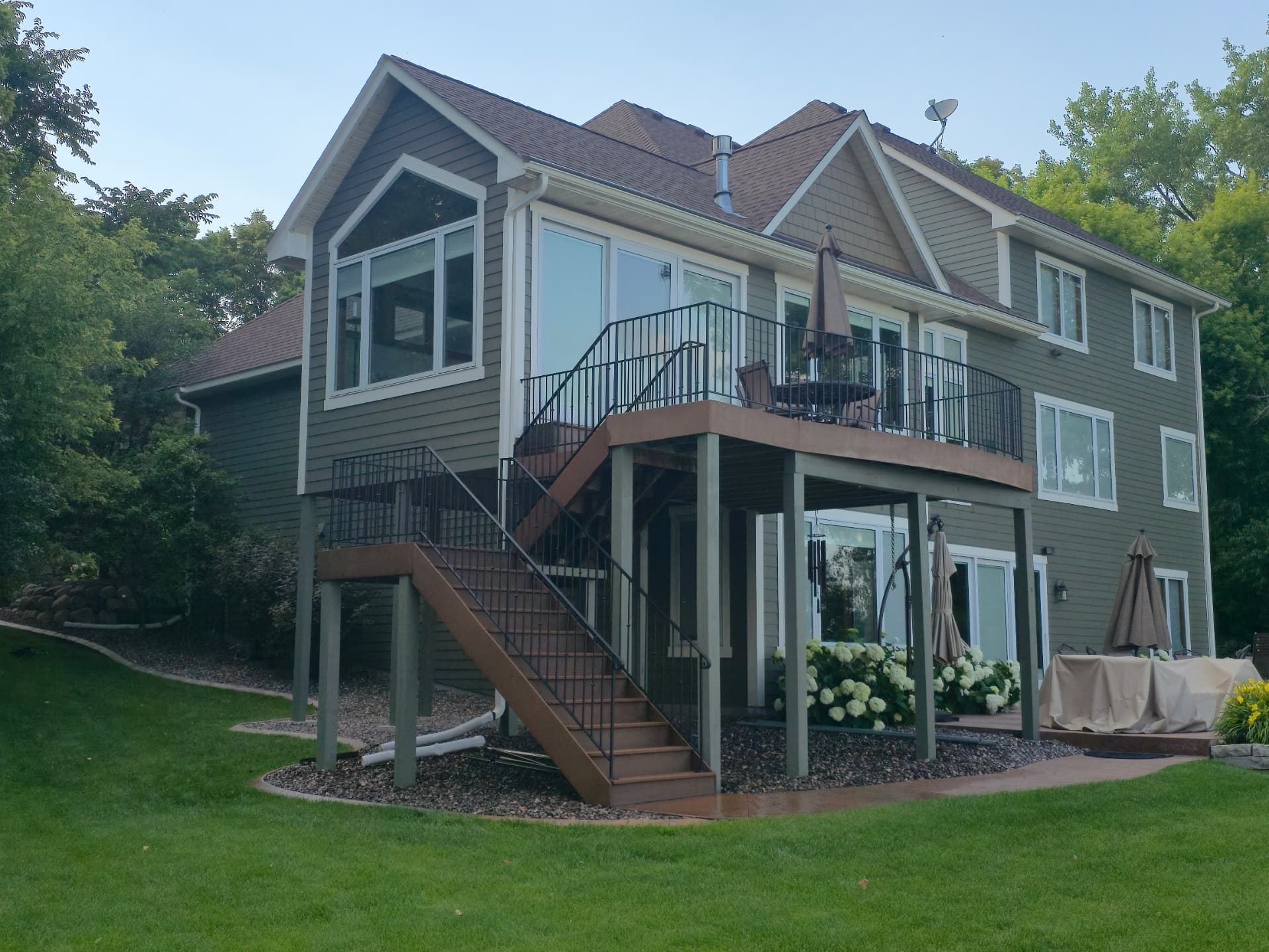 Two-Story Lakeside Home with Elevated Deck · Mounds View, MN · Full siding, trim, deck skirting, stairs Two-Story Home Exterior Painting with Deck in Mounds View, MN