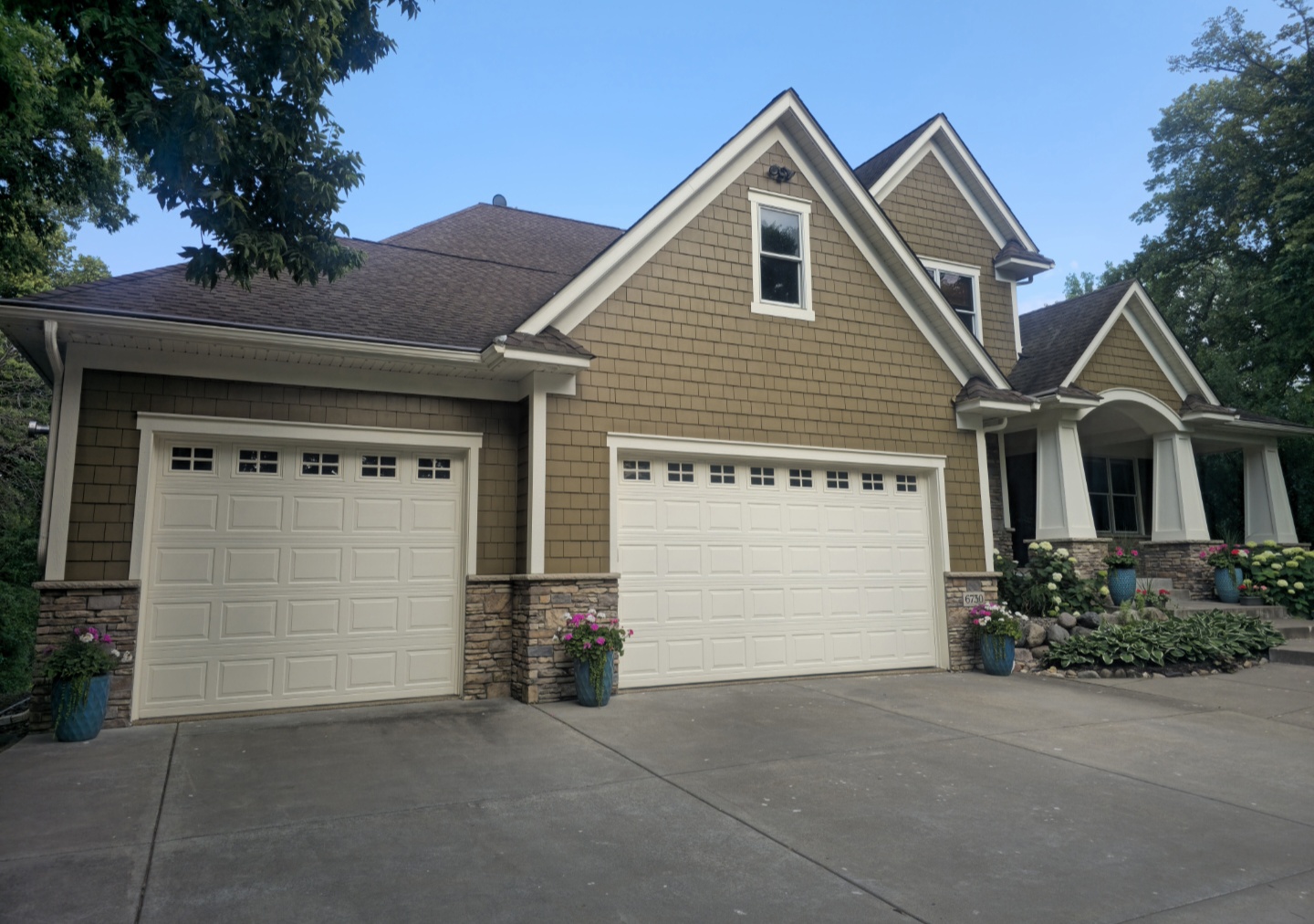 Finished exterior house painting with shake siding and painted garage doors in the Twin Cities