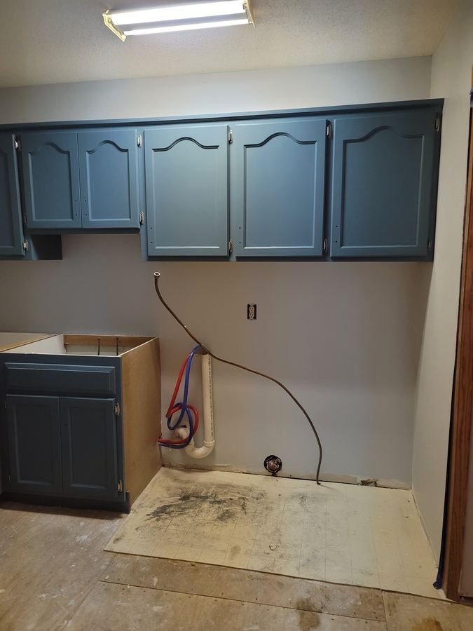 Kitchen cabinets after professional refinishing with modern blue finish