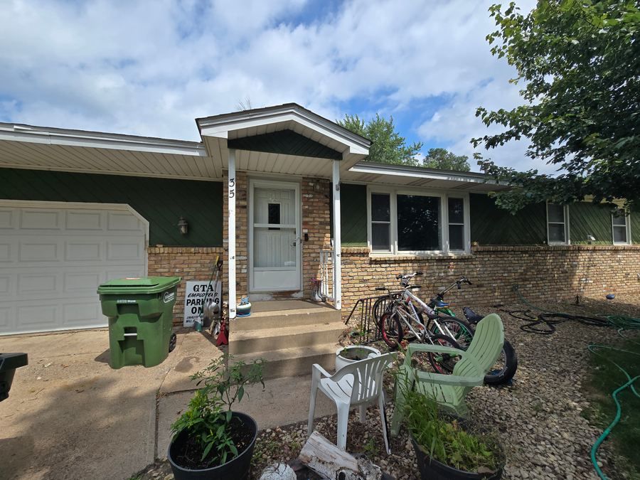 House exterior before painting with faded green siding