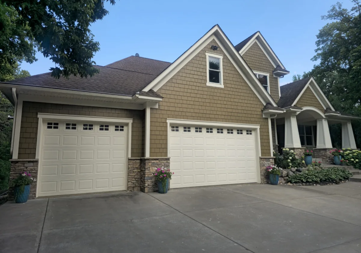 Finished exterior house painting with shake siding and painted garage doors in the Twin Cities
