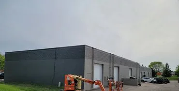 Commercial building exterior repainted in a dark finish in Roseville, Minnesota