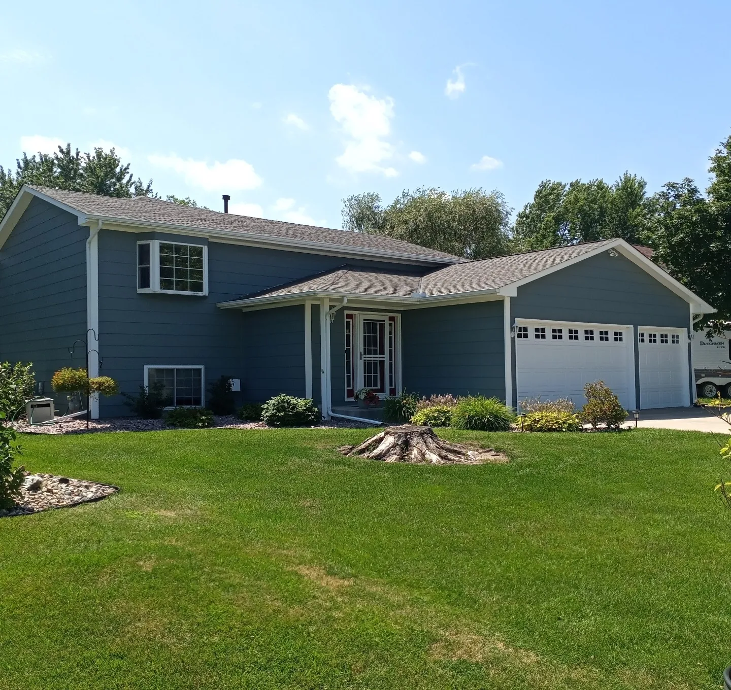 Blue Split-Level with Two-Car Garage · Lino Lakes, MN · Siding, garage doors, trim coordination Blue Split-Level Two-Car Garage in Lino Lakes, MN
