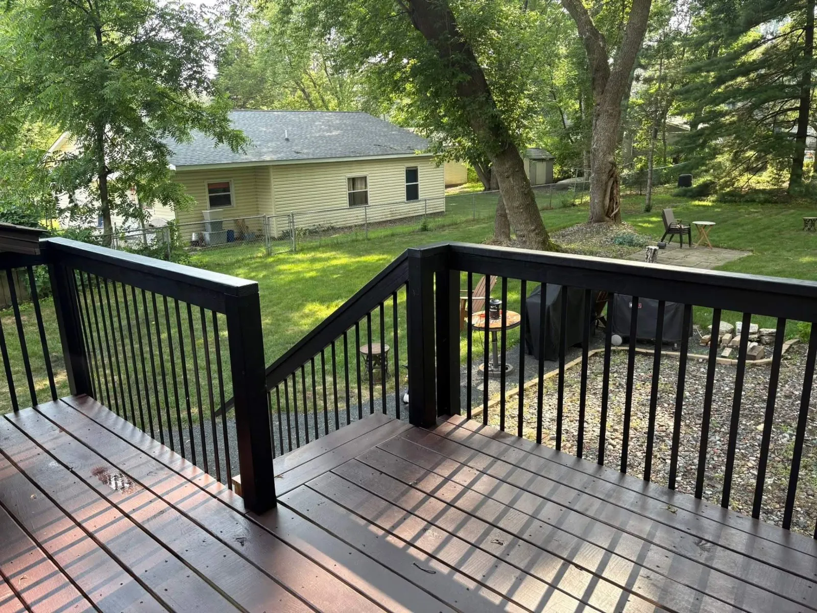 Professional Deck Staining with Black Railings · Shoreview, MN · Deck stain, railing paint, two-tone design Professional Deck Staining with Black Railings in Shoreview, MN