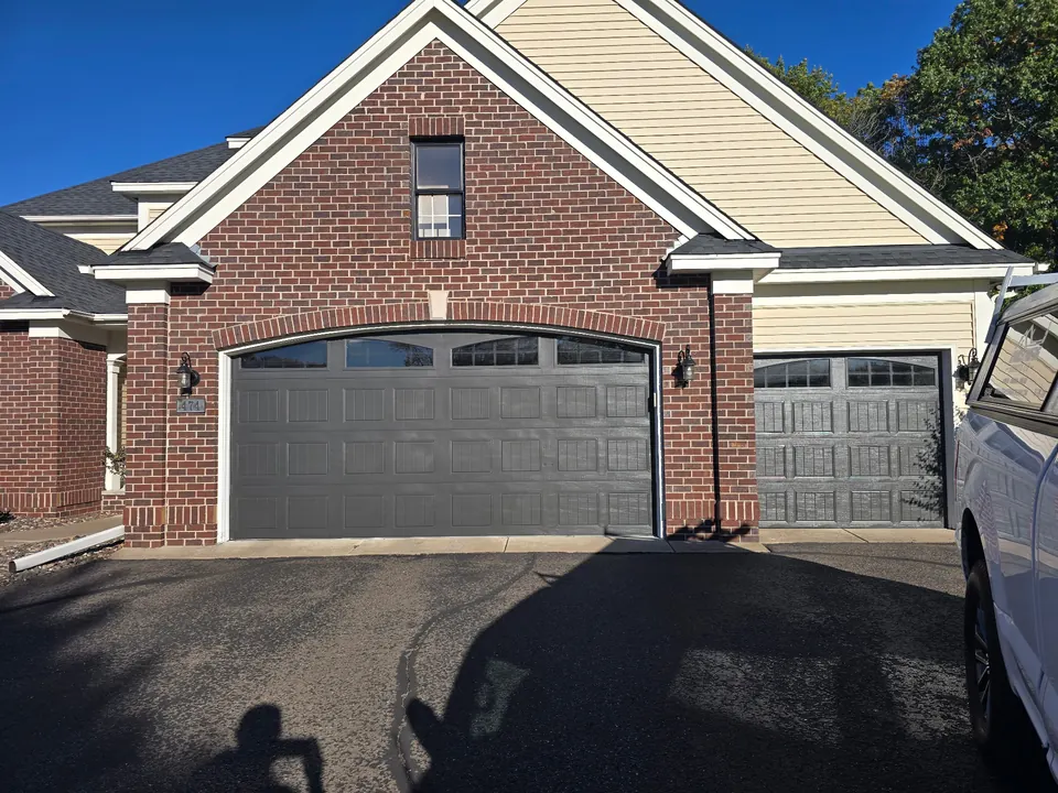 Freshly painted gray garage door on a Minnesota home exterior